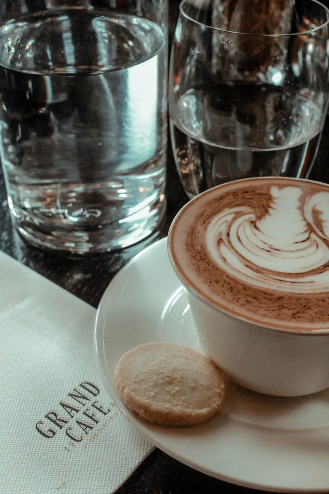 Coffee and a biscuit on a café table